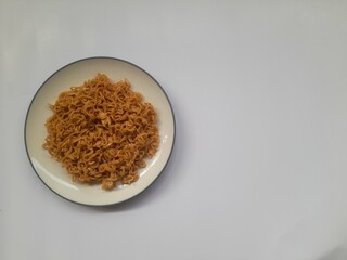 fried noodle (mie goreng) food on plate on white background. background concept of healthy food, food recipe, dish, meal, cuisine, breakfast, culinary, lunch, lifestyle, gourmet,eat,cook,carbohydrates