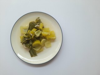 Mustard greens (sayur bening) food on plate top view on white background. background concept of healthy food, food recipes, breakfast, diet, organic, nutritious, nutrition,restaurant,cuisine,lifestyle