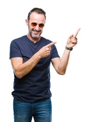 Middle age hoary senior man wearing sunglasses over isolated background smiling and looking at the camera pointing with two hands and fingers to the side.