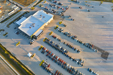 View from above of dealers outdoor parking lot with many brand new cars in stock for sale. Concept...