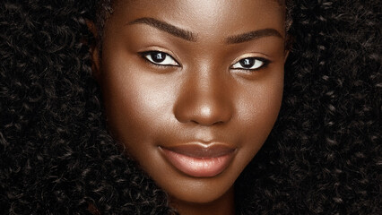 Close up fashion beauty face portrait of young beautiful african american woman with curly afro hair and clean glowing skin