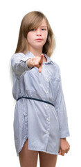 Young blonde toddler wearing blue shirt pointing with finger to the camera and to you, hand sign, positive and confident gesture from the front