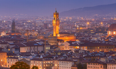 Palazzo Vecchio and Arnolfo Tower in Florence at sunset.