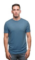 Fototapeta premium Handsome young casual man with serious expression on face. Simple and natural looking at the camera.