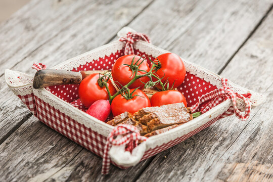 bread and tomatoes at a rustic table set mountain cabin