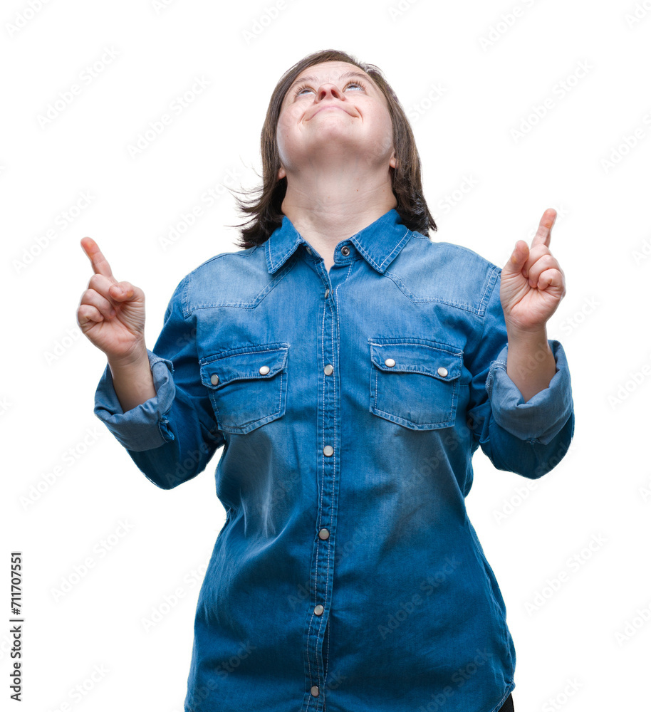 Canvas Prints Young adult woman with down syndrome over isolated background amazed and surprised looking up and pointing with fingers and raised arms.