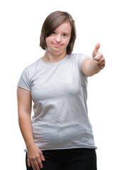 Young adult woman with down syndrome over isolated background doing happy thumbs up gesture with hand. Approving expression looking at the camera with showing success.