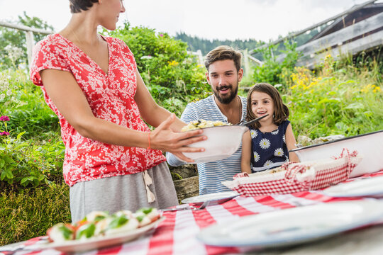 happy family in the garden in the mountains