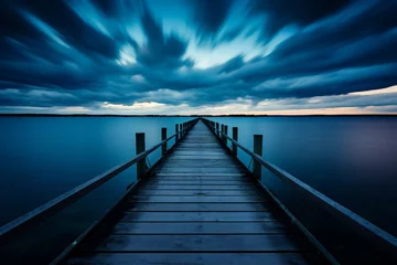 Foto op Plexiglas Wooden jetty on the beach with blue sky and white clouds © Jioo7