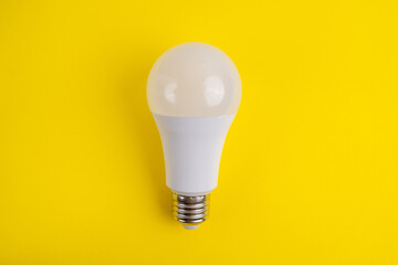 Paper and light bulb on a colored background. Idea and business concept. Place for text