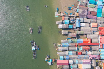 Aerial view of Koh Panyee, The Floating village urban city town houses, lake sea or river. Nature landscape fisheries and fishing tools at Pak Pha, Phang Nga, Thailand. Aquaculture farming