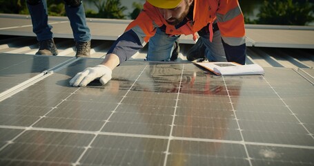 engineer man contractor worker architect construction manager in uniform and hardhat work to maintenance checking an operation and efficiency performance of photovoltaic solar panels on roof