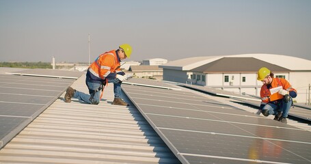 engineer man contractor worker architect construction manager in uniform and hardhat work to maintenance checking an operation and efficiency performance of photovoltaic solar panels on roof