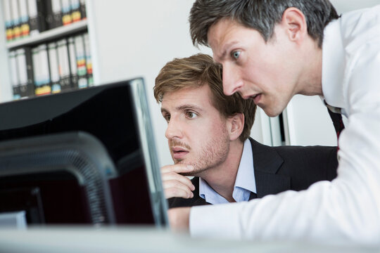 business colleagues working close together in small office digitalization