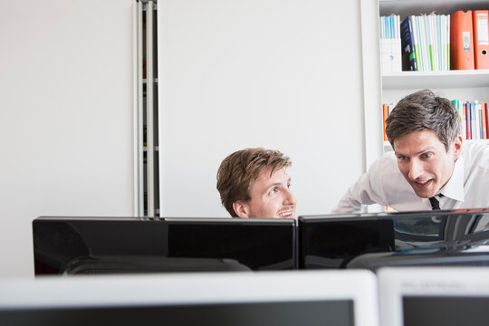 Female business manager discussing a project in the office to colleague