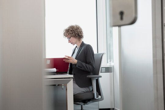 Female business manager going through a folder in the office