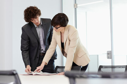 business people brainstorming in a glass-walled conference room 