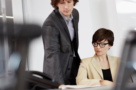 business people brainstorming in a glass-walled conference room 