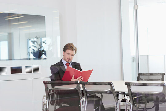 business man with important document brainstorming in a glass-walled conference room 