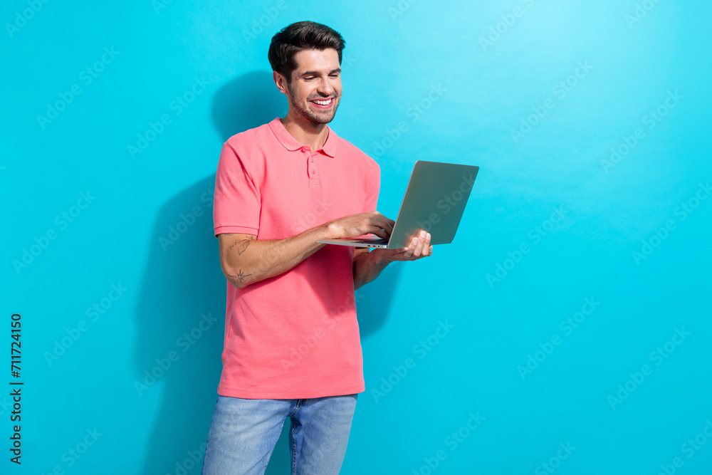 Poster photo of young cheerful working guy in pink t shirt connect wifi in new location when using laptop i
