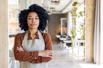 Portrait of a serious and self-confident African-American businesswoman, owner of a restaurant,...