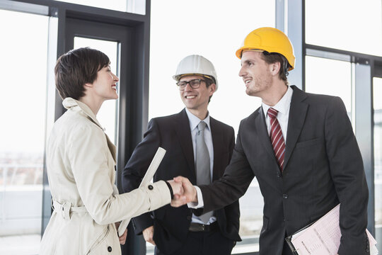 developer, owner and architect of new building inspecting the progress