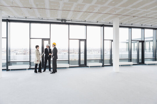 developer, owner and architect of new building inspecting the progress