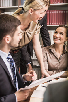 cheerful lawyers meeting in law office 