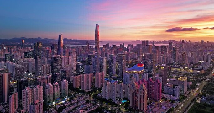Aerial forward shot of Shenzhen Financial District skyline and natural scenery