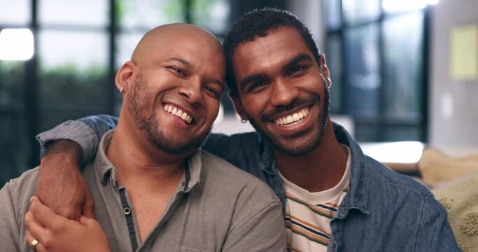 Home, gay couple and face with laugh, smile and love with bonding and hug in a living room. Partner, sofa and lgbt pride with marriage together in happy house with queer romance and relationship care