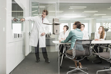 Colleagues at a pharmaceutical company meeting with clients in a conference room. Munich, Bavaria, Germany