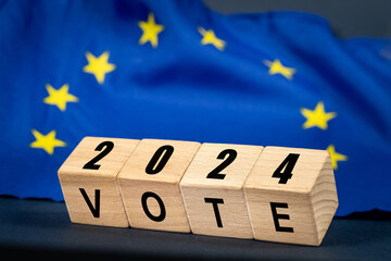 European Union vote, the word Vote on wooden blocks against the background of the EU flag, the...