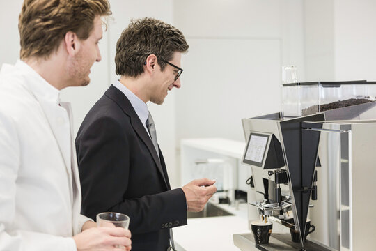 Colleagues at a pharmaceutical company get coffee together. Munich, Bavaria, Germany