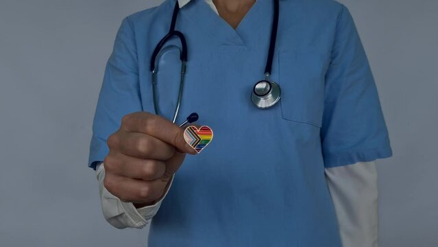 Doctor with stethoscope and LGBT badge. Medical care for sexual minorities