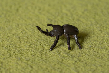 Plastic figurine of a hornet beetle.