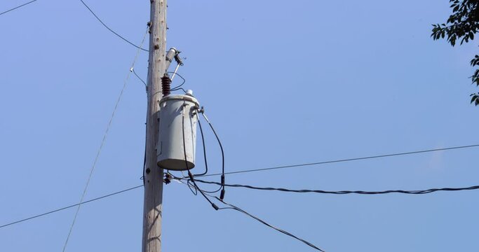 Electric pole with electric transformer with blue sky