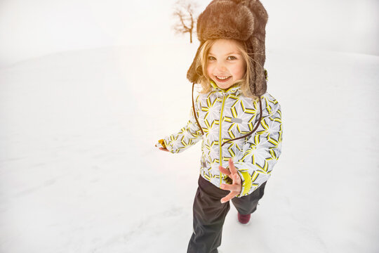 Young girl playing in a snowy landscape in winter. Wolfratshausen, Germany