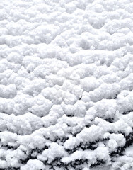 Snow on the roof of a car in winter. Close-up