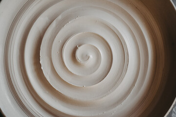 A beautiful spiral, a helical line on a clay surface. Pottery, clay texture decorated with a spiral...