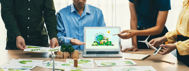 Green city and waste management illustrate displayed on laptop. Business team presenting green design to customer. ESG environment social governance and Eco conservative concept. Closeup. Delineation.
