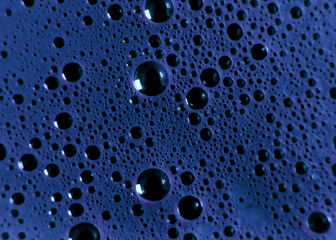 Abstract surface of floating bubbly spheres in a blue liquid. Cold gloomy bubble pattern, creating an otherworldly alien watery landscape.
