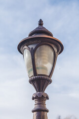 Fototapeta na wymiar An old fashioned street lamp against a blue sky