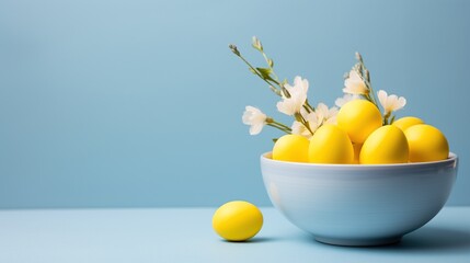 A cheerful arrangement of yellow eggs and fresh spring flowers in a light blue bowl against a matching backdrop, capturing the essence of springtime renewal and joy.