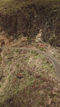 Outdoor sport in the Canary Islands, Cyclists between mountains, Difficult roads of Gran Canaria. Vertical Drone Recorded Cycling to 4K Quality.