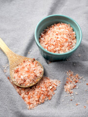 Pink salt on a wooden spoon.