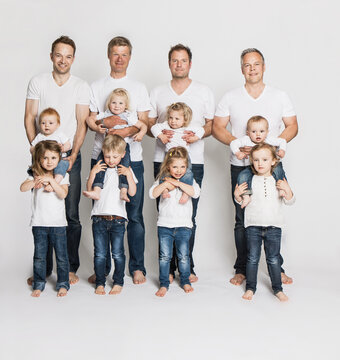 studio portrait  groupshot four fathers with eight toddlers