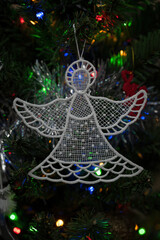 Knitted angel Christmas decorations on the Christmas tree.