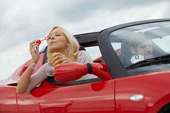 young woman with an electric car