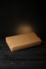 craft paper boxes for food packaging on a black background. Fast food delivery. Mockup