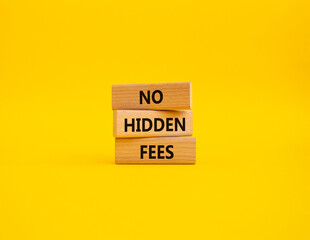 No hidden fees symbol. Concept word No hidden fees on wooden blocks. Beautiful yellow background....